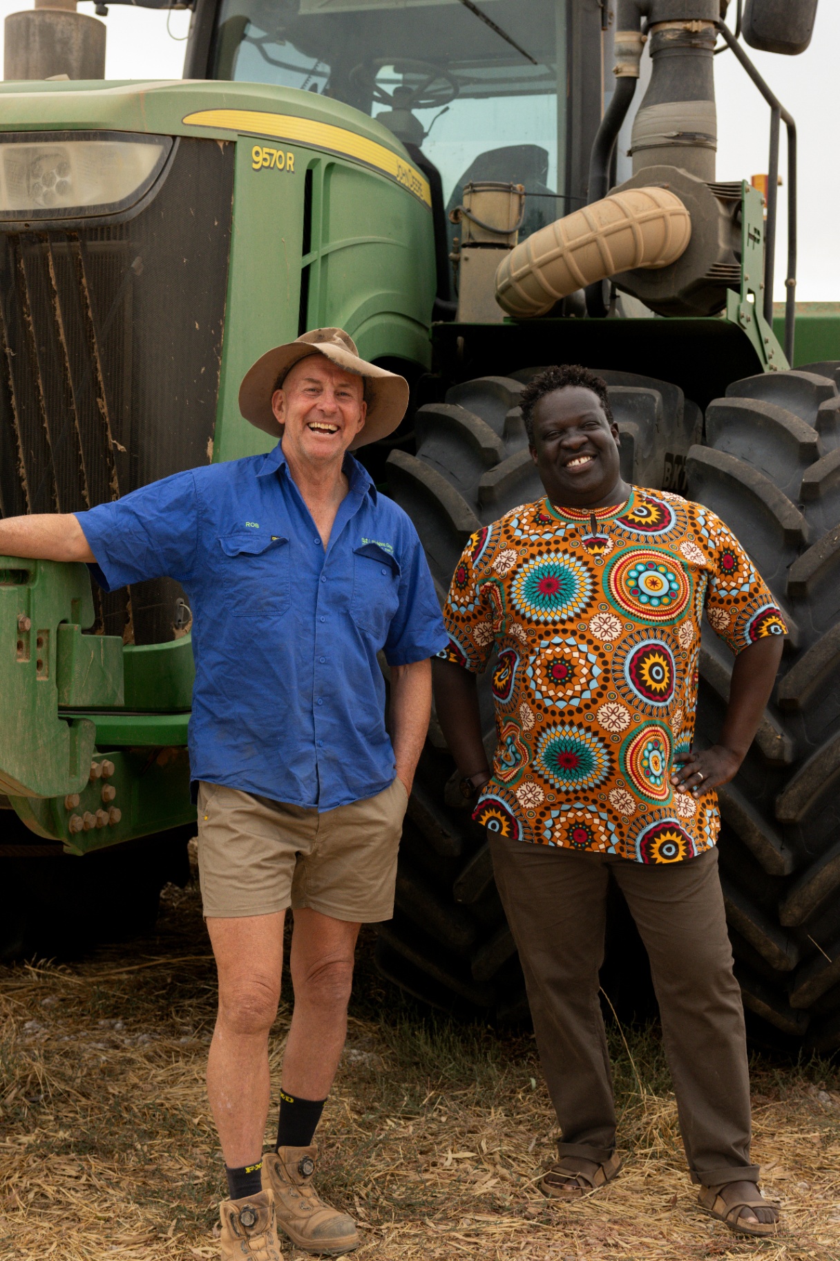 Rob and Ken standing together in front of a tractor on Rob's Riverina farm.